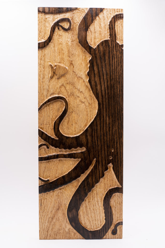 Purchase a piece of wood art depicting an octopus and a fish